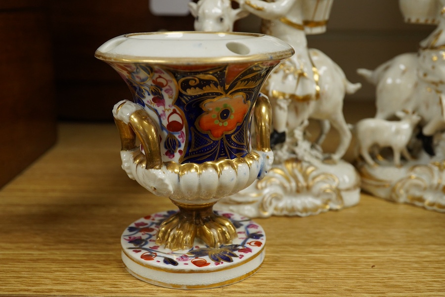 A pair of Bloor Derby white and gilt porcelain figures, Tailor and his Wife, together with a pair of small Imari pattern campaign spill vases, largest 14cm high. Condition - some restoration